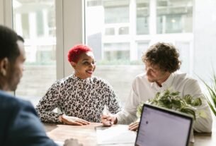 Casual business meeting with diverse professionals discussing a project.